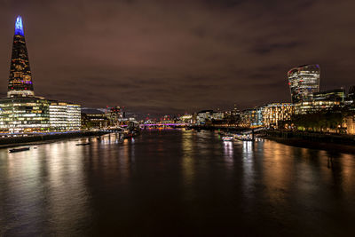Illuminated buildings in city at waterfront