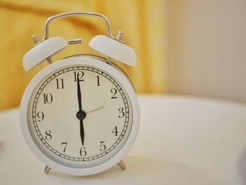Close-up of clock on table at home