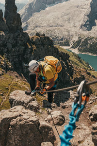 Man standing on rock against mountains