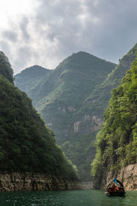 Scenic view of river amidst mountains against sky