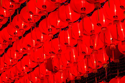 Low angle view of illuminated red lanterns hanging at night