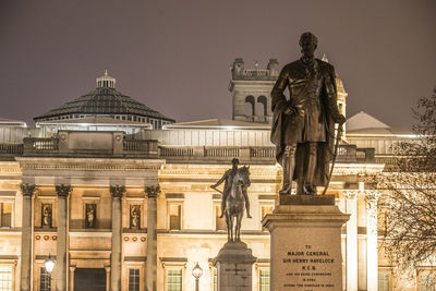 Low angle view of statue against historic building