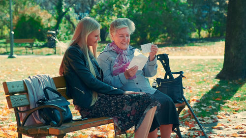 Woman sitting on bench in park