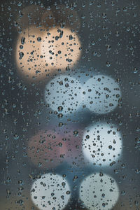 Full frame shot of raindrops on glass window