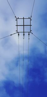 Low angle view of electricity pylon against sky