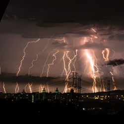 Lightning in sky over city at night