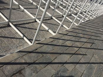 Tilt shot of metallic frames on footpath during sunny day