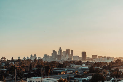 View of buildings in city against clear sky