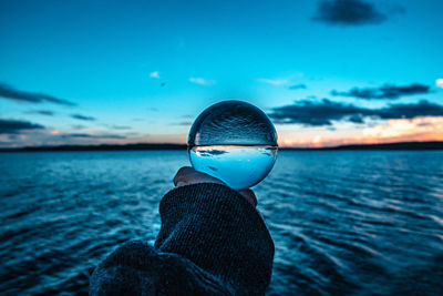 Lensball in golden hour over the water against the sky