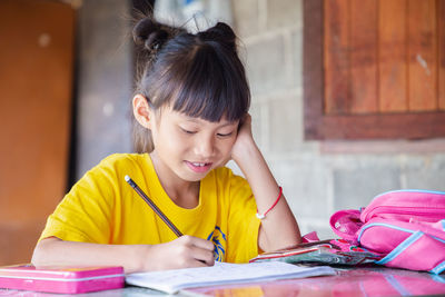 Portrait of a girl sitting on table