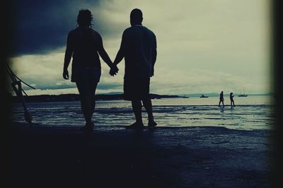 People on beach at sunset