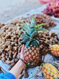 Cropped image of hand holding fruits at market