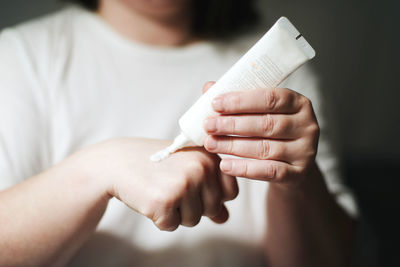 Midsection of woman holding paper