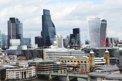 Skyscrapers against cloudy sky