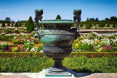 Close-up of statue against plants in park