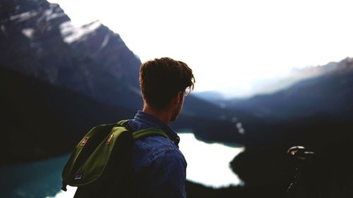 Man looking at mountains against sky