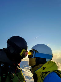 Rear view of man standing against clear sky