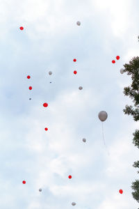 Low angle view of balloons against sky