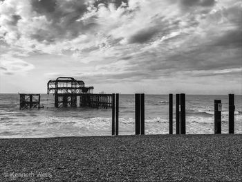 West pier from beach against sky