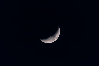 Low angle view of half moon against sky at night