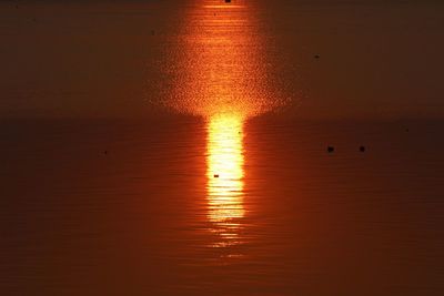 Scenic view of sea against orange sky