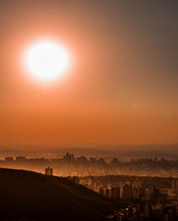 Silhouette cityscape against sky during sunset