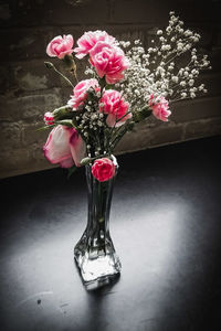Close-up of pink flower vase on table