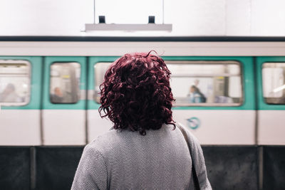 Rear view of woman on train at railroad station