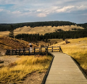 Narrow pathway along countryside landscape