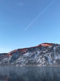 Low angle view of mountains against clear blue sky