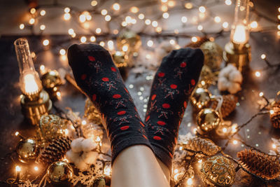 Low section of woman with christmas lights