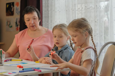 Girl drawing on paper at home