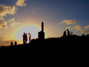 Silhouette of people at sunset