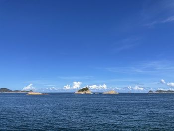 Scenic view of sea against blue sky