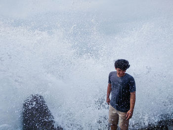 Full length of man standing in sea