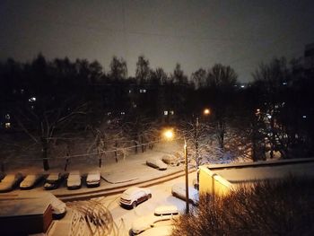 View of snow covered street at night