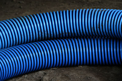 High angle view of blue pipes on field at construction site