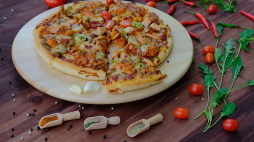 High angle view of pizza on cutting board