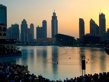 People at waterfront during sunset