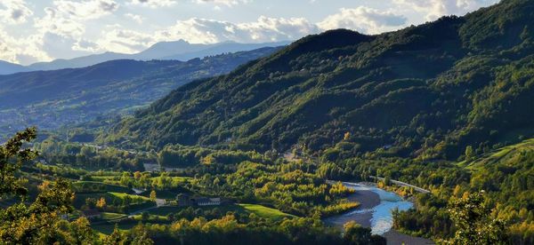 Scenic view of river amidst mountains against sky