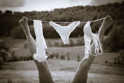 Low section of woman with lingerie tied on string