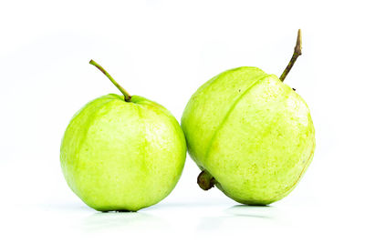 Close-up of guavas against white background