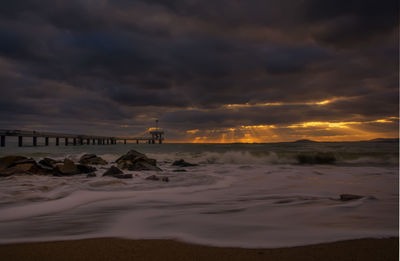 Scenic view of beach against sky during sunset