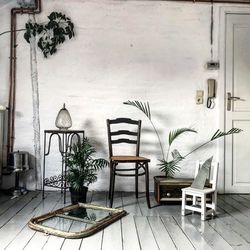 Empty chairs and table against wall at home