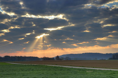 Scenic view of field against sky during sunset