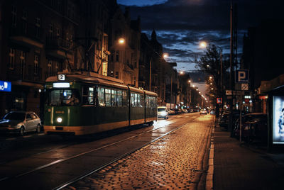 Tram on track in city at dusk