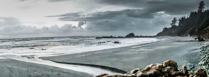 View of beach against cloudy sky