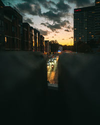 View of city street and buildings at dusk
