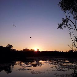 Scenic view of lake at sunset