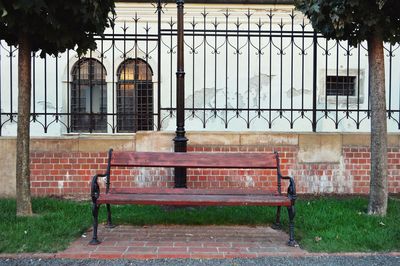 Empty bench against building